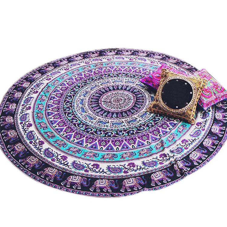 Colorful round mandala tapestry rug with vibrant bohemian patterns and decorative accent pillows