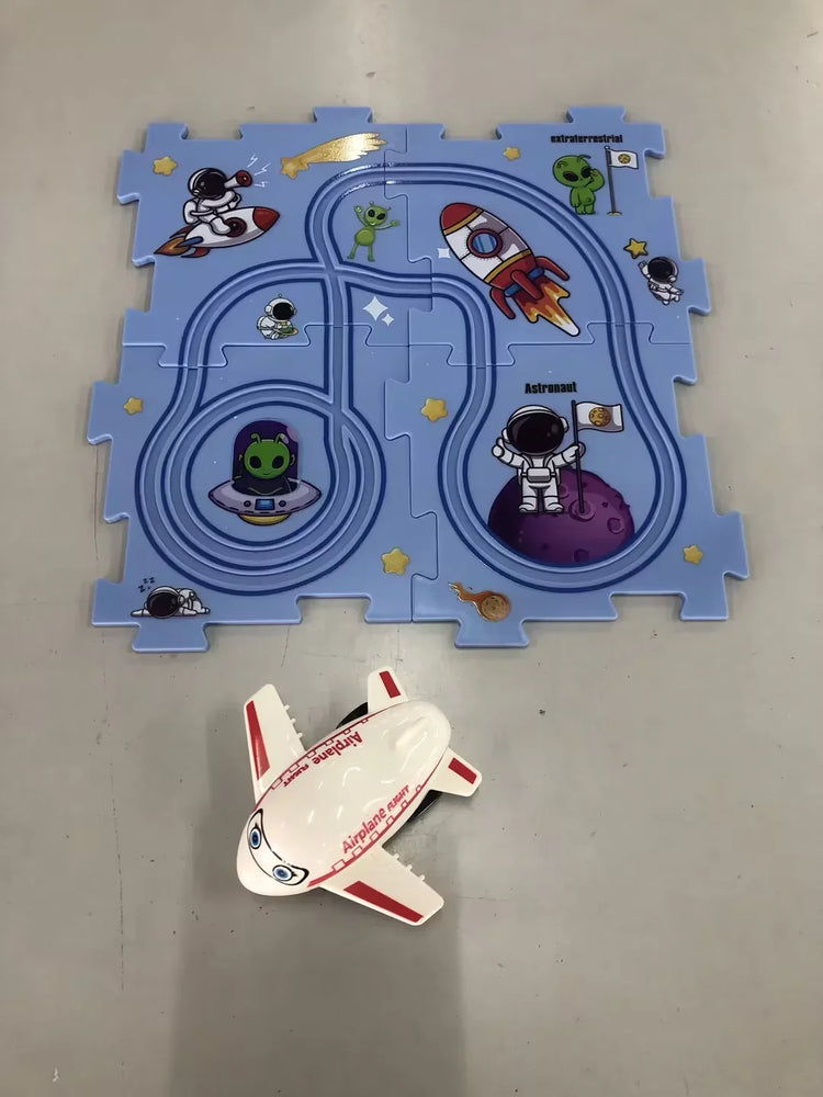 Blue space-themed kids puzzle mat with cartoon astronauts, aliens, rockets, and a toy airplane.