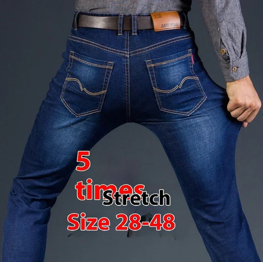 Man wearing dark blue stretch denim jeans, slim fit, flexible material, rear view
