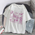 White oversized graphic tee with purple futuristic designs, paired with light denim shorts