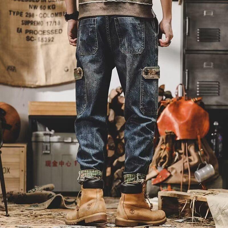 Loose fit blue denim cargo pants with side pockets, paired with tan work boots