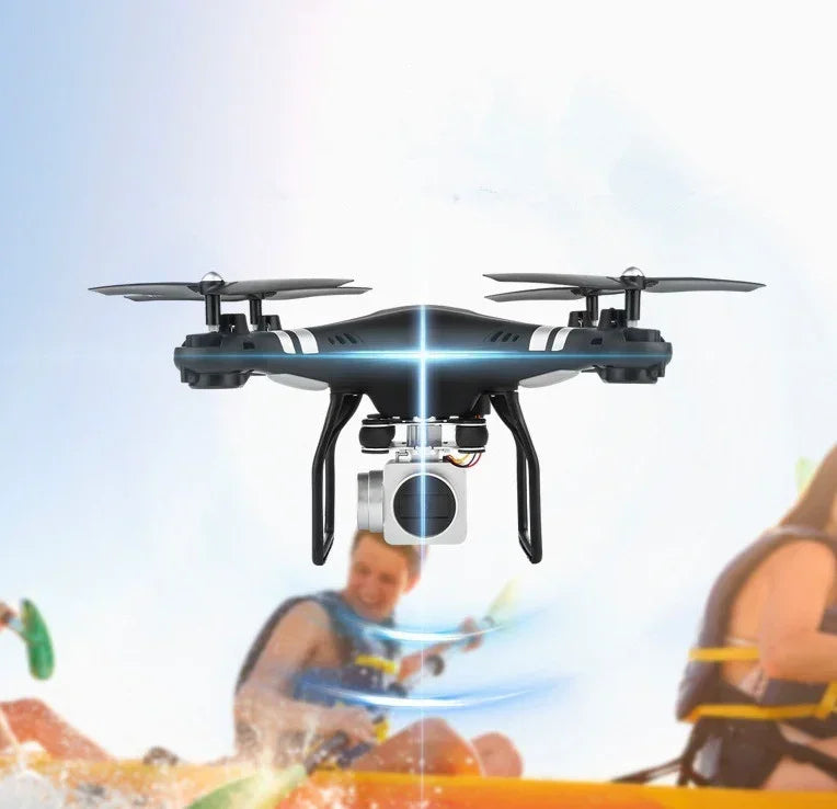 Sleek black quadcopter drone with camera flying outdoors, action sports scene in background