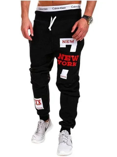 Black jogger pants with bold red and white New York streetwear graphics, slim fit, casual style