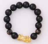 Black beaded bracelet with matte round beads and gold dragon charm, unisex fit