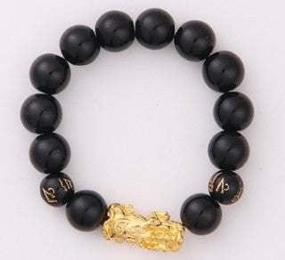 Black beaded bracelet with matte round beads and gold dragon charm, unisex fit