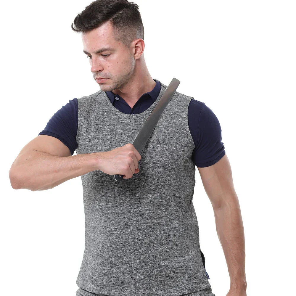 Man wearing a fitted gray sleeveless protective vest over navy short-sleeve shirt