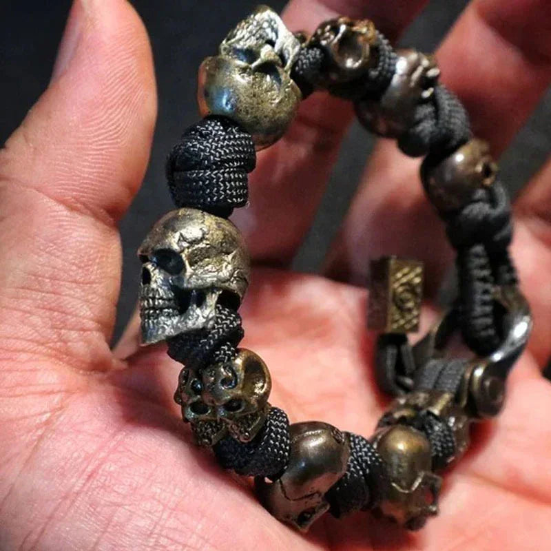 Black paracord bracelet with bronze skull beads, rugged streetwear accessory, close fit