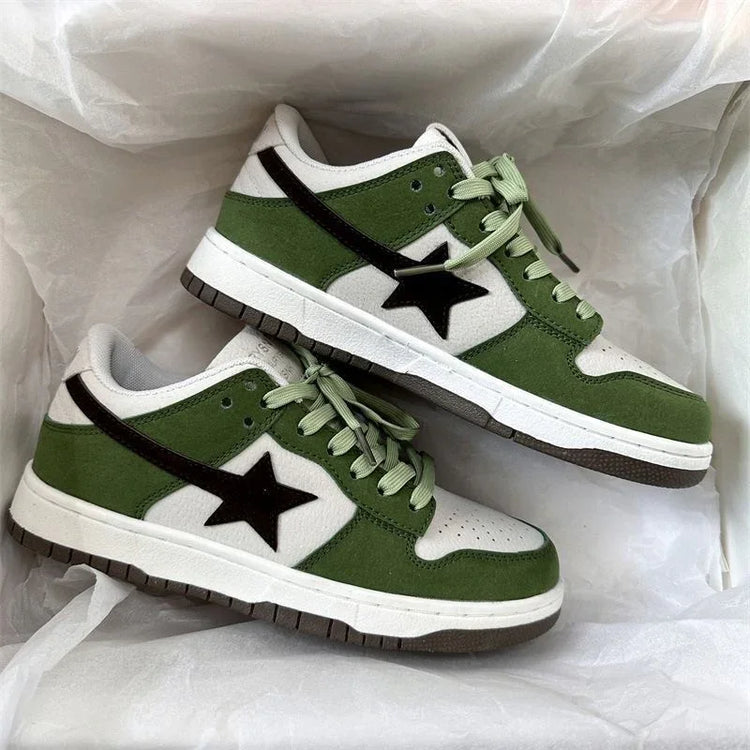 Green and white low-top suede sneakers with black star design and light green laces