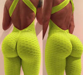 Back view of a woman wearing a neon yellow textured jumpsuit with criss-cross open back and body-hugging fit.