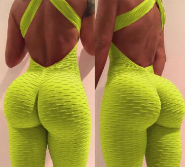 Back view of a woman wearing a neon yellow textured jumpsuit with criss-cross open back and body-hugging fit.