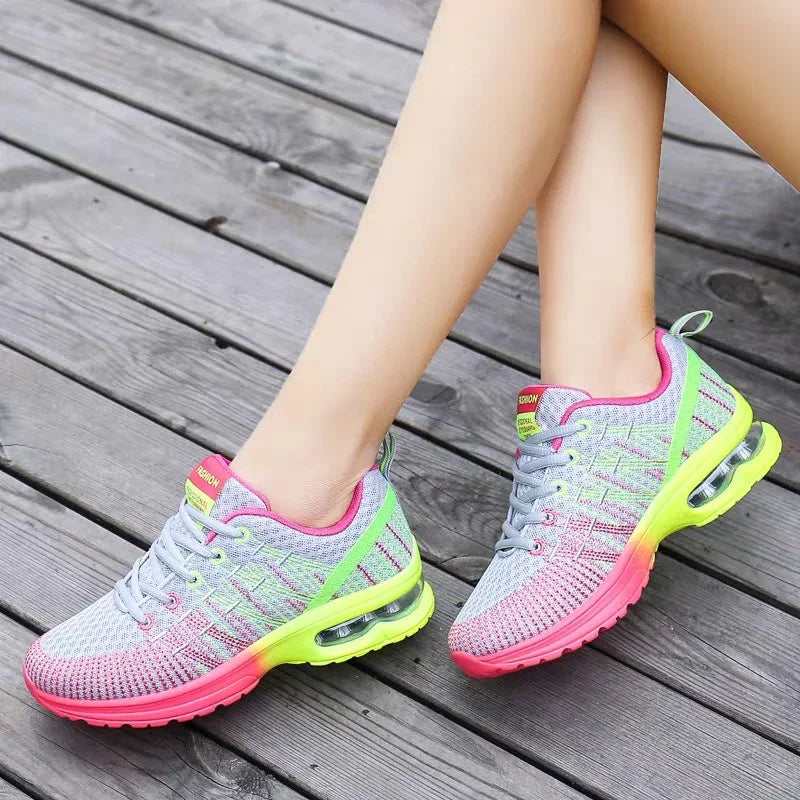 Gray mesh sneakers with neon pink and yellow accents, air sole, lightweight athletic fit