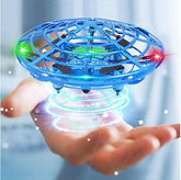 Blue futuristic toy drone with LED lights hovering above an open hand indoors.