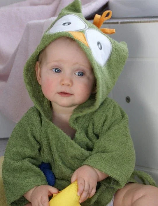 Baby wearing green hooded towel robe with cartoon owl design, soft terry material, relaxed fit