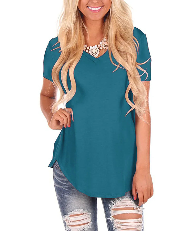 Woman wearing teal short sleeve V-neck top with relaxed fit and distressed jeans