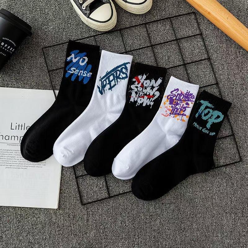 Streetwear crew socks in black and white cotton with colorful graffiti text graphics, casual fit