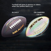 Reflective leather football with white laces and gold lettering, glowing under camera flash