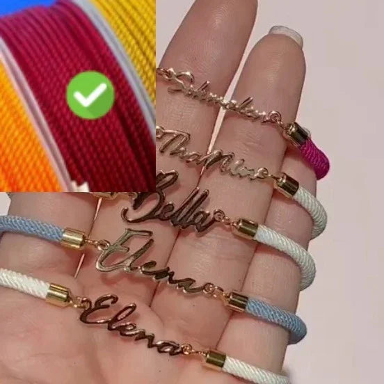 Hand holding nameplate bracelets with gold metal, pastel rope bands, modern street style