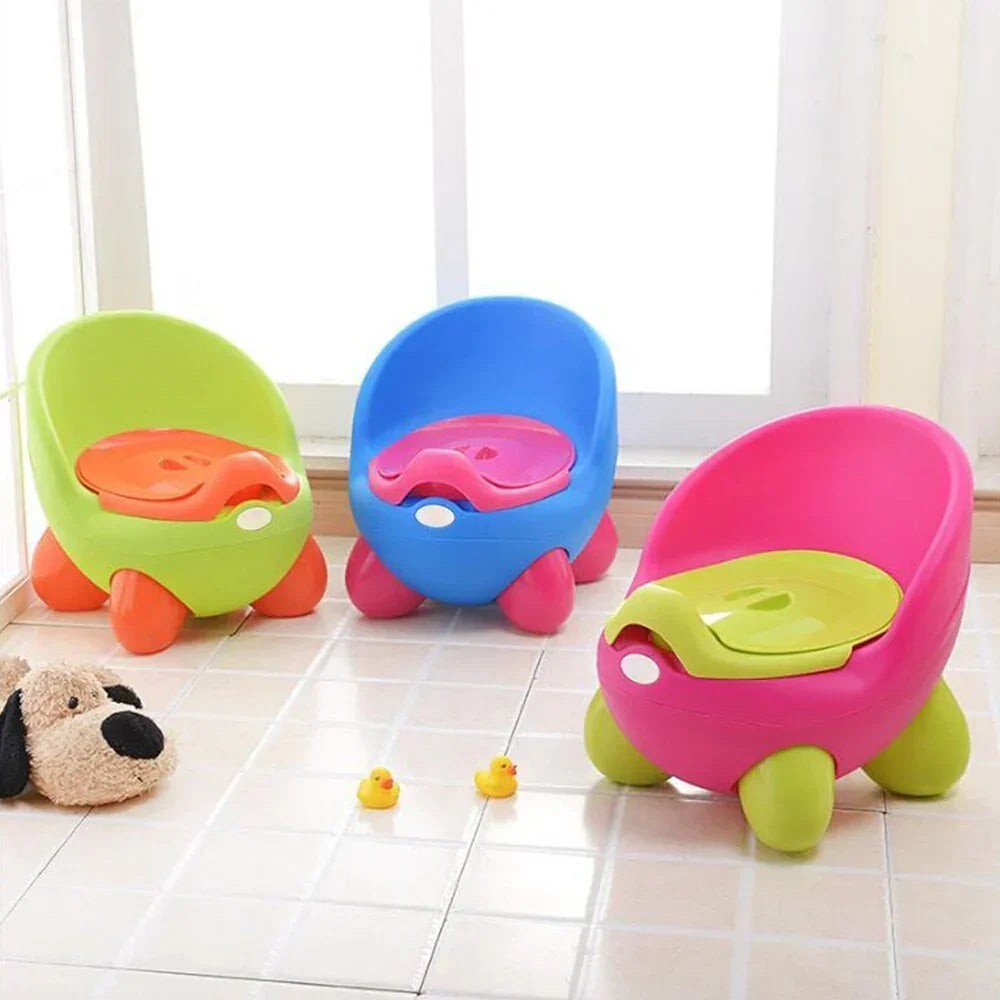 Colorful plastic toddler potty chairs with rounded seats and lids on tiled floor