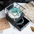 Elegant blue and white artificial rose in clear display box with black jewelry drawer