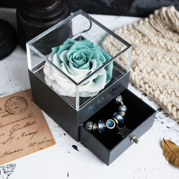 Elegant blue and white artificial rose in clear display box with black jewelry drawer
