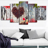 Modern living room with light gray sofa, black and white throw pillows, and abstract wall art.