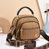 Brown leather crossbody bag with gold hardware, adjustable strap, and multiple zip pockets
