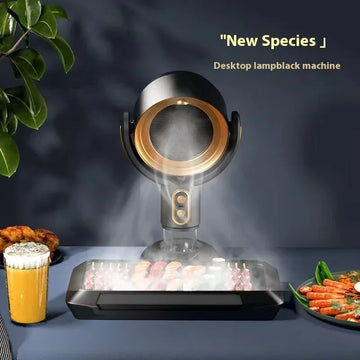 Modern black and gold desktop smokeless grill with built-in smoke extractor, grilling skewers.