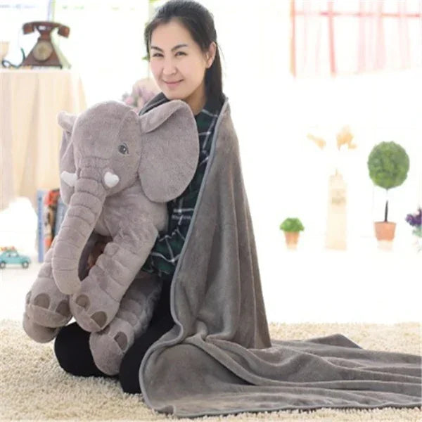 Woman with soft gray fleece blanket, casual fit, holding plush elephant toy