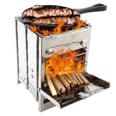 Stainless steel portable wood stove with flames and a skillet cooking meat on top.