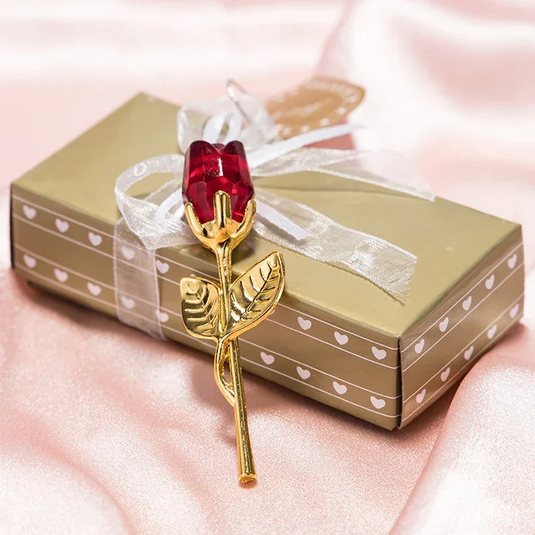 Gold and red rose brooch on gift box with ribbon, elegant accessory, satin background