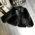 Black faux fur jacket with leather collar, relaxed fit, streetwear style on gray floor