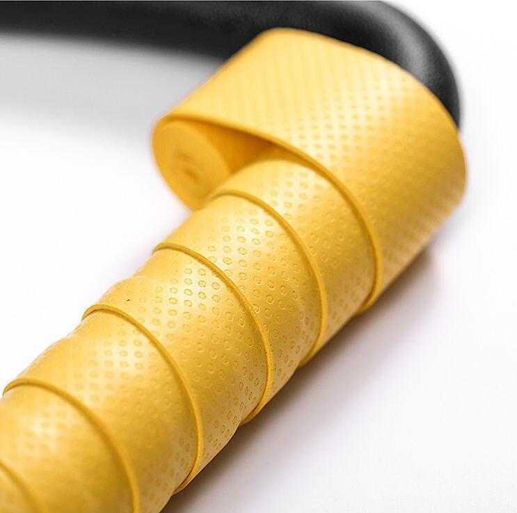 Yellow textured synthetic grip wrap on black curved handle, close-up detail