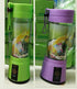 Green and purple portable electric blenders with clear glass jars and silicone straps