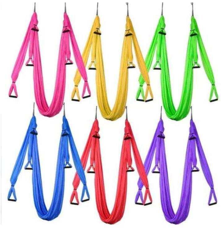 Colorful nylon aerial yoga hammocks with sturdy loops, available in pink, yellow, green, blue, red, and purple.