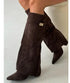 Brown suede knee-high boots with pointed toes and relaxed wide fit, modern streetwear style