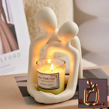 Minimalist cream ceramic candle holder shaped like abstract embracing couple, holding lit candle, modern home decor.