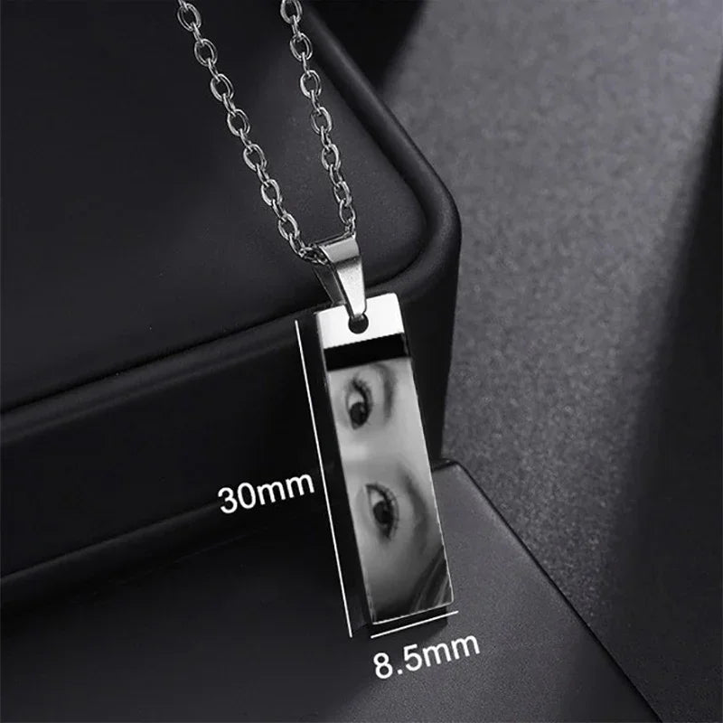 Rectangular silver metal pendant necklace with reflective finish and measurements
