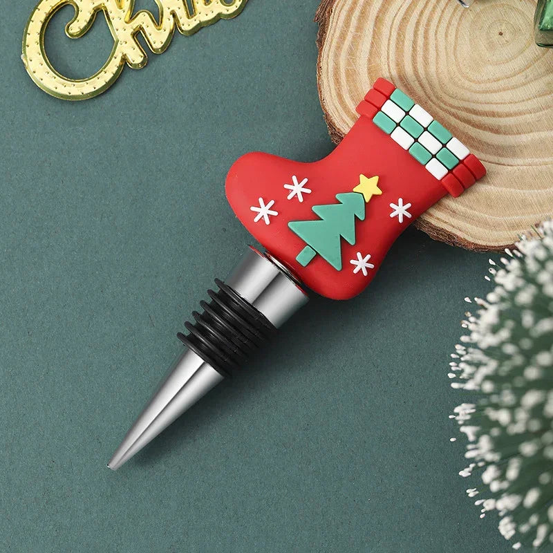 Red Christmas stocking wine bottle stopper with tree and snowflake design, silicone and metal.