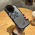 Glittery silver phone case with black robot design, metallic finish, slim fit, tech accessory