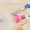 Porous water spray from colorful water gun on sandy surface