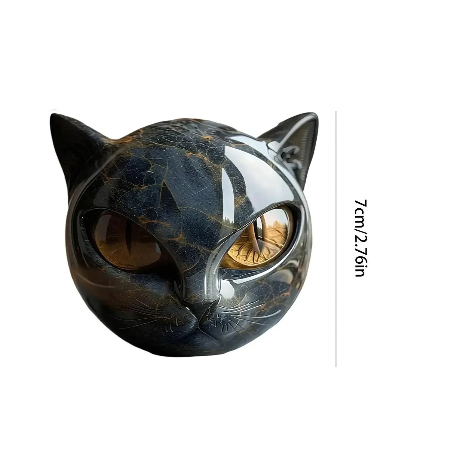 Glossy black and gold marble cat head sculpture with amber eyes, 7cm tall