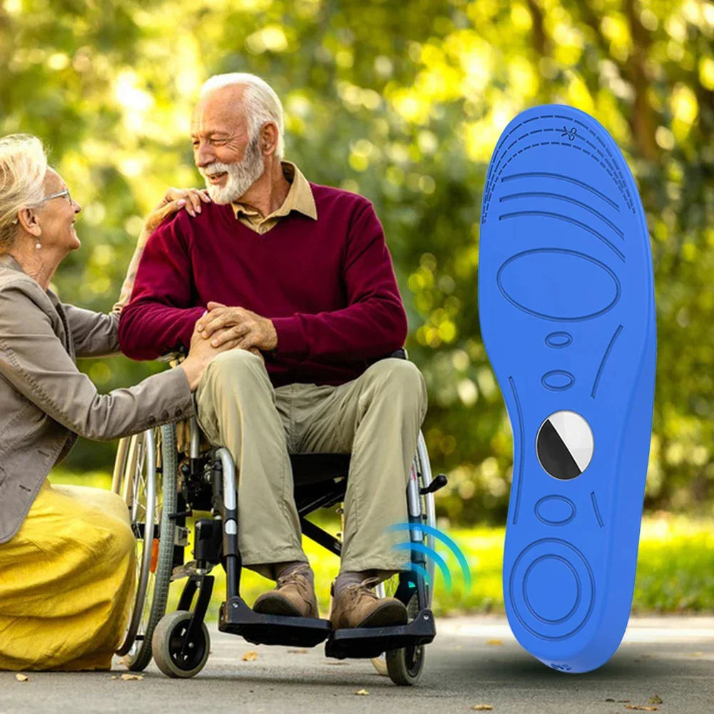 Elderly man in wheelchair wearing beige pants and burgundy sweater, large blue orthopedic insole overlay, outdoor setting