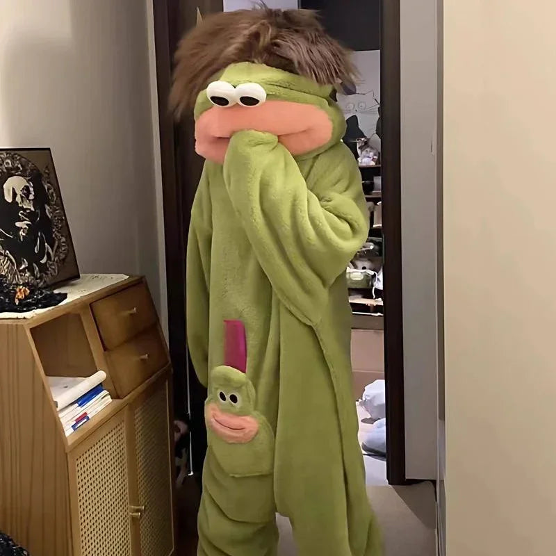 Person wearing an oversized green plush onesie with cartoon face and relaxed fit