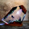 Illuminated resin art block with fantasy dragon, castle, and glowing landscape on wooden base
