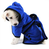 White puppy wearing a blue fleece hooded robe with black trim and tie, cozy fit.