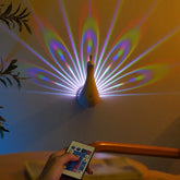 Peacock-shaped wall light with remote, multicolor LED projection on wall