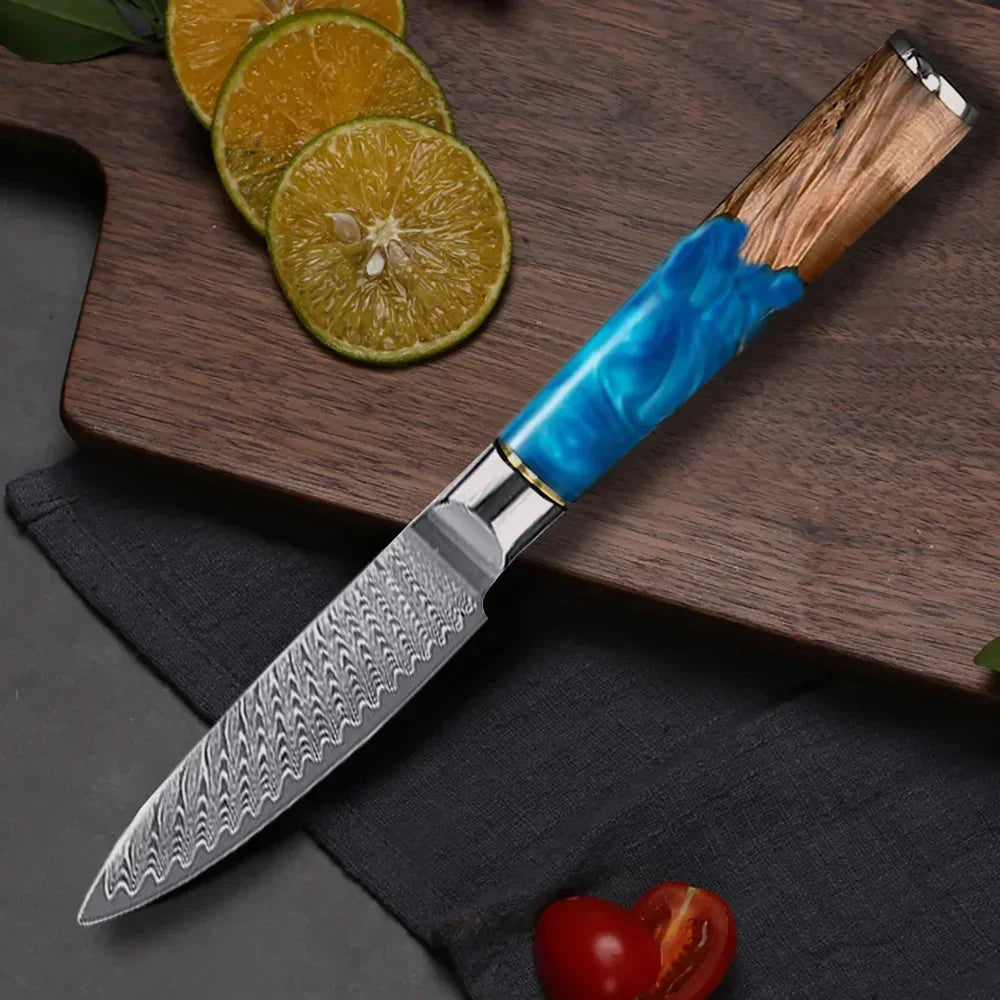 Damascus steel kitchen knife with blue resin and wood handle on cutting board