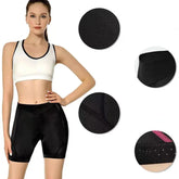 Woman in black high-waisted compression shorts and white crop top, closeup of fabric and stitching
