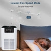 White air purifier with digital display beside sleeping person, quiet 10dB operation for restful sleep