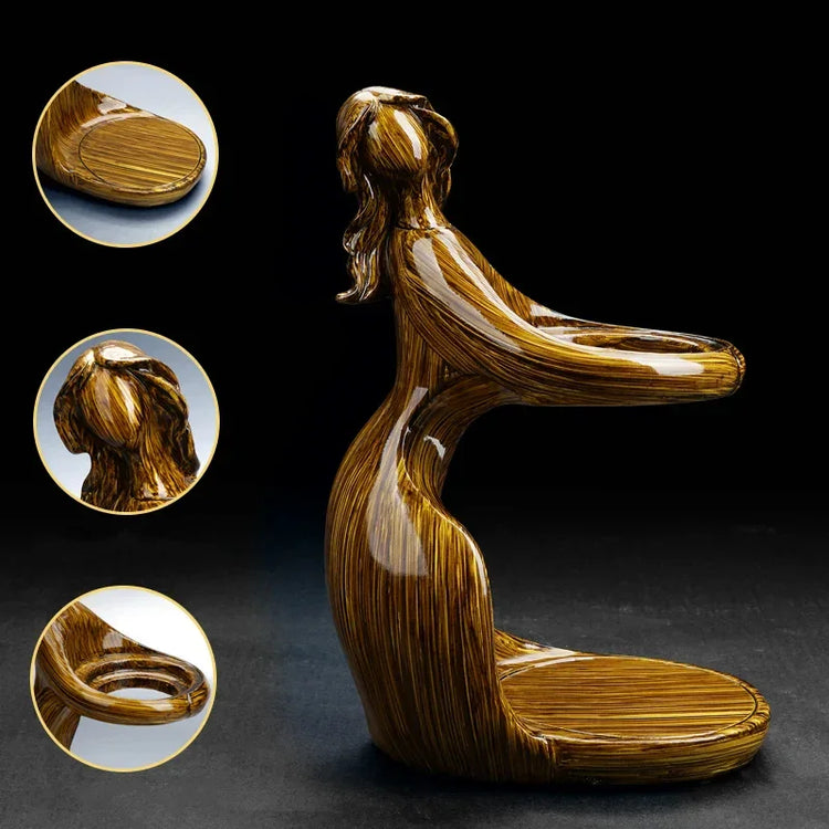 Glossy brown abstract resin figurine featuring a kneeling woman, modern home decor accent
